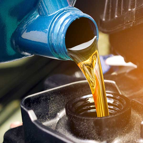 Pouring oil to motor engine