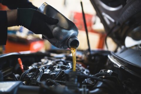 Mechanic changing engine oil at Red River Oil Company in Texas & Arkansas
